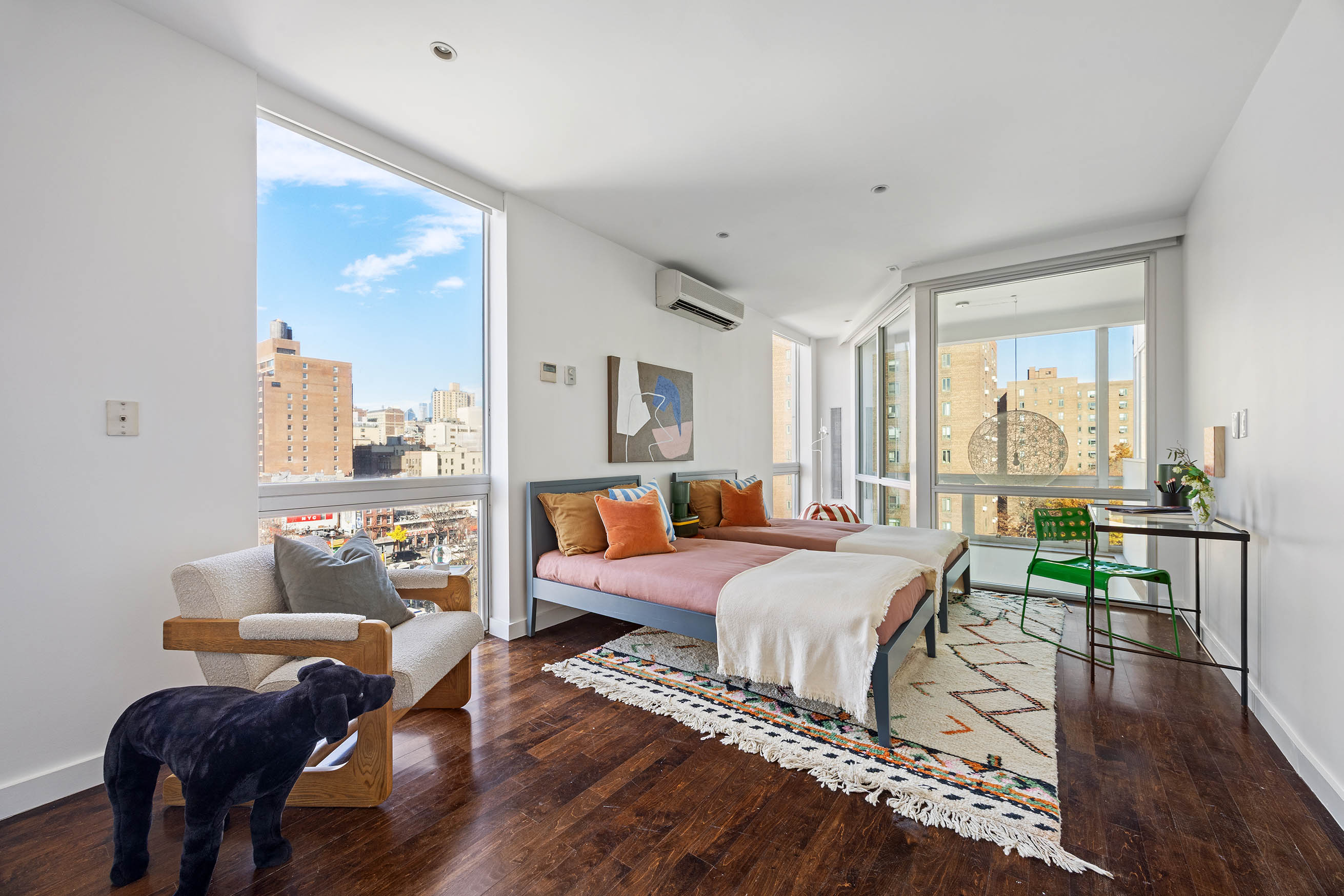 425 East 13th Street, Unit PHFG Manhattan, NY 10009 - Photo 18 of 31 a bed room with two beds and a large window