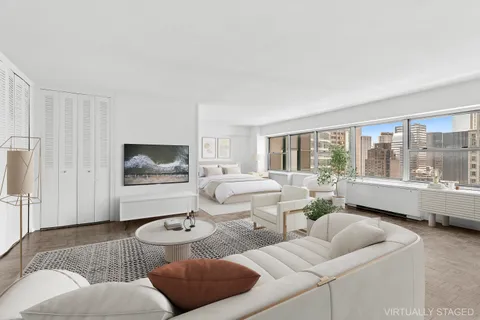 a living room with furniture and a large window