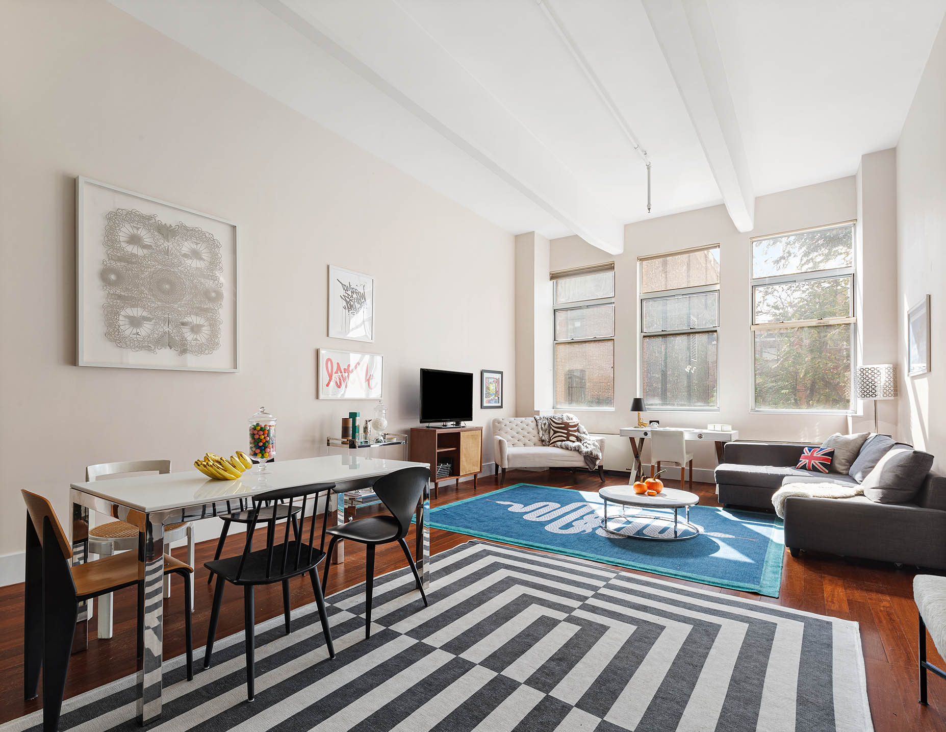 60 Broadway, Unit 2P Brooklyn, NY 11249 - Photo 3 of 8 a living room with furniture and a floor to ceiling window