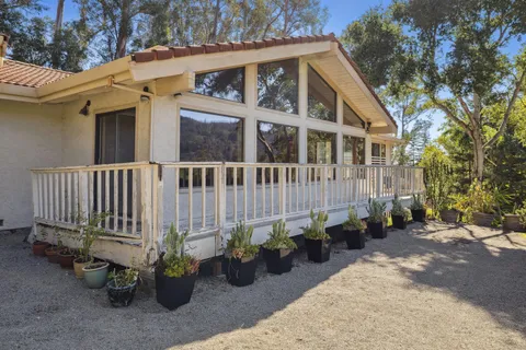 a view of a house with a chairs in a patio