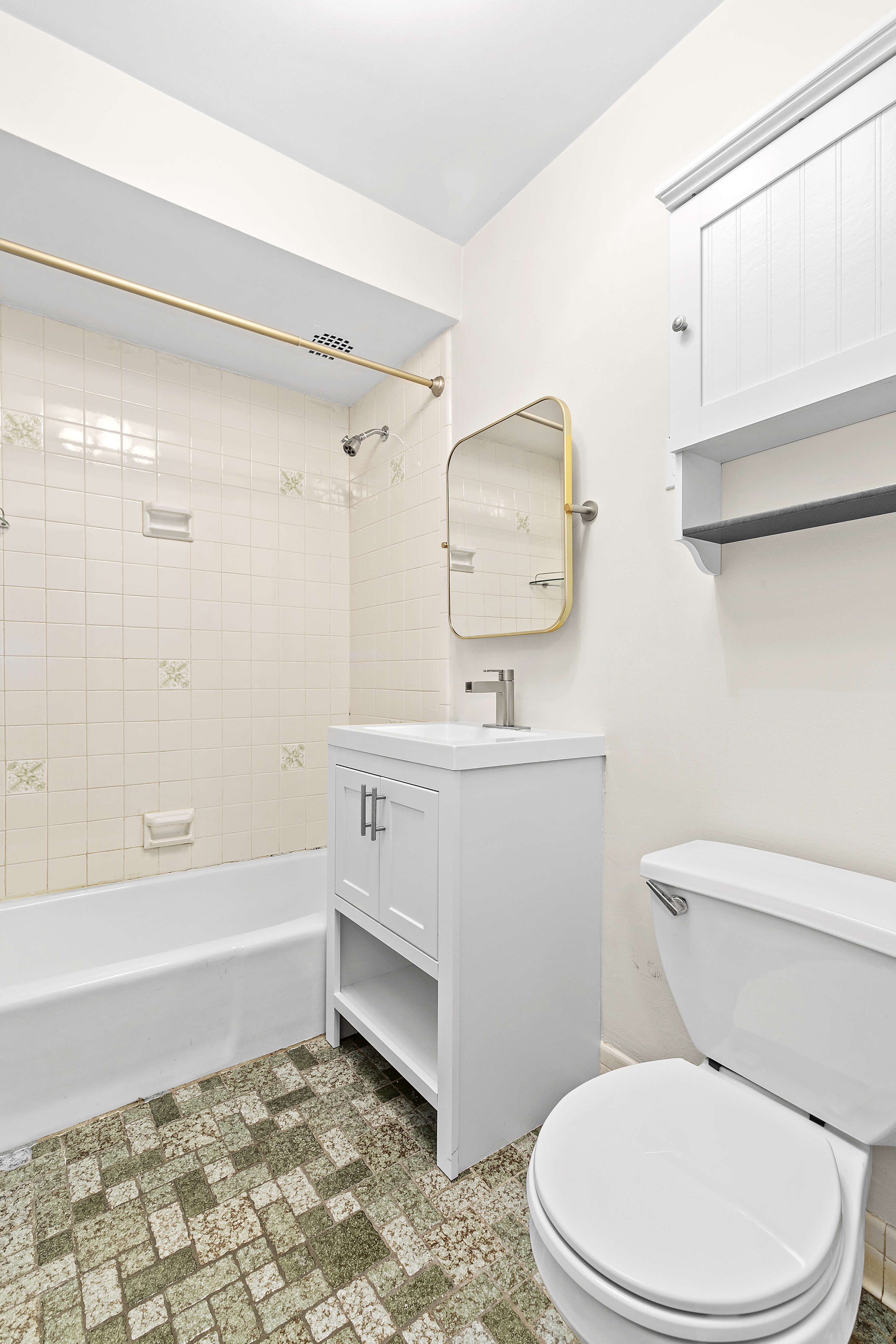 59 East 74th Street, Unit 7 Manhattan, NY 10021 - Photo 4 of 5 a bathroom with a sink a toilet and bathtub