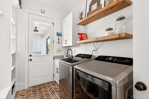 a bathroom with a double vanity sink mirror and toilet