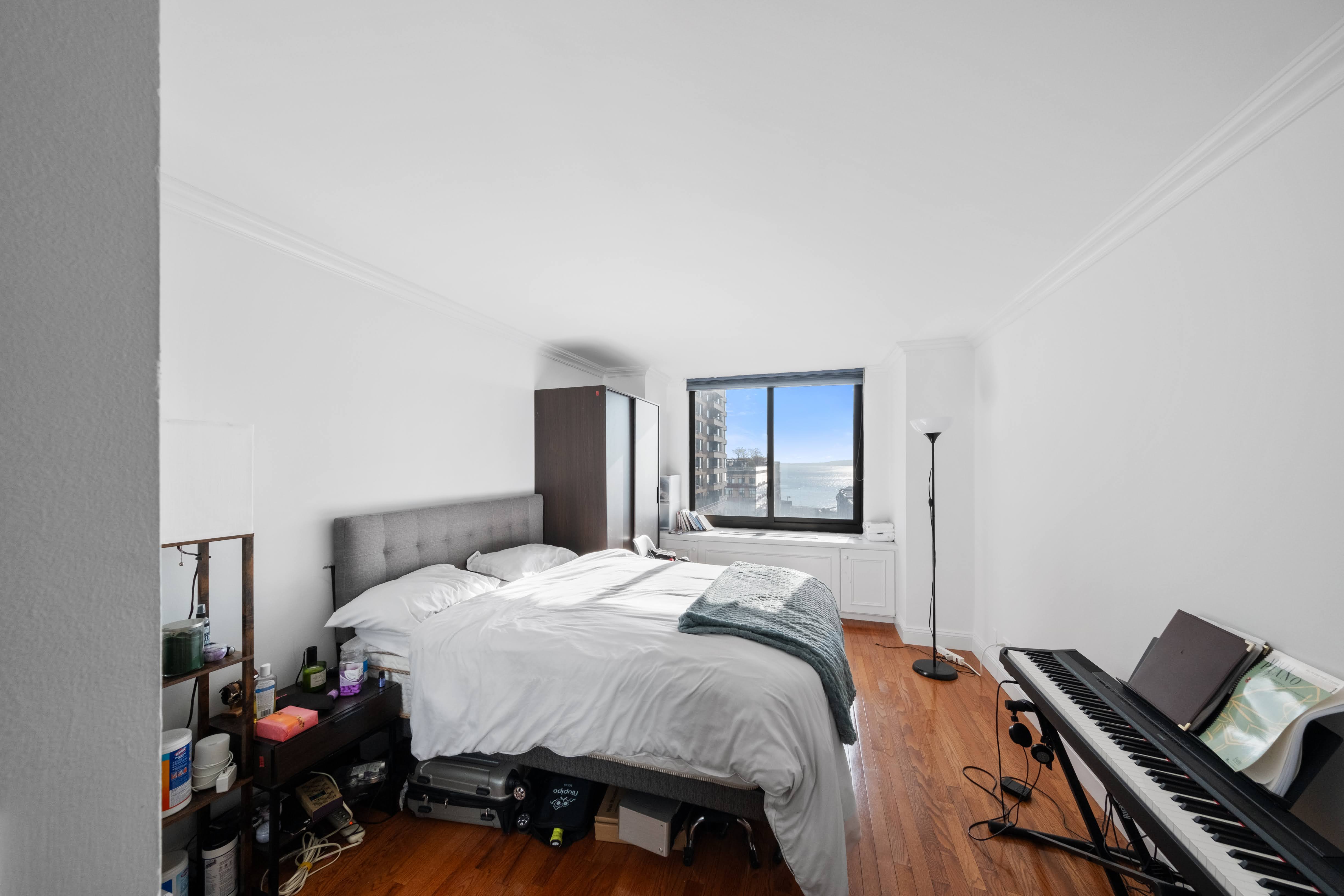 200 Rector Place, Unit 16F Manhattan, NY 10280 - Photo 6 of 25 a bedroom with a bed and dresser