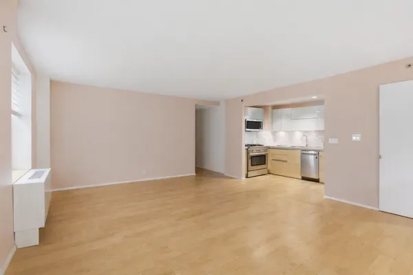 a view of a kitchen with a sink and a refrigerator