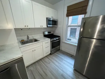 a kitchen with a refrigerator stove and sink