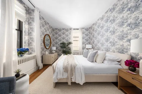 a bed room with a bed and a potted plant