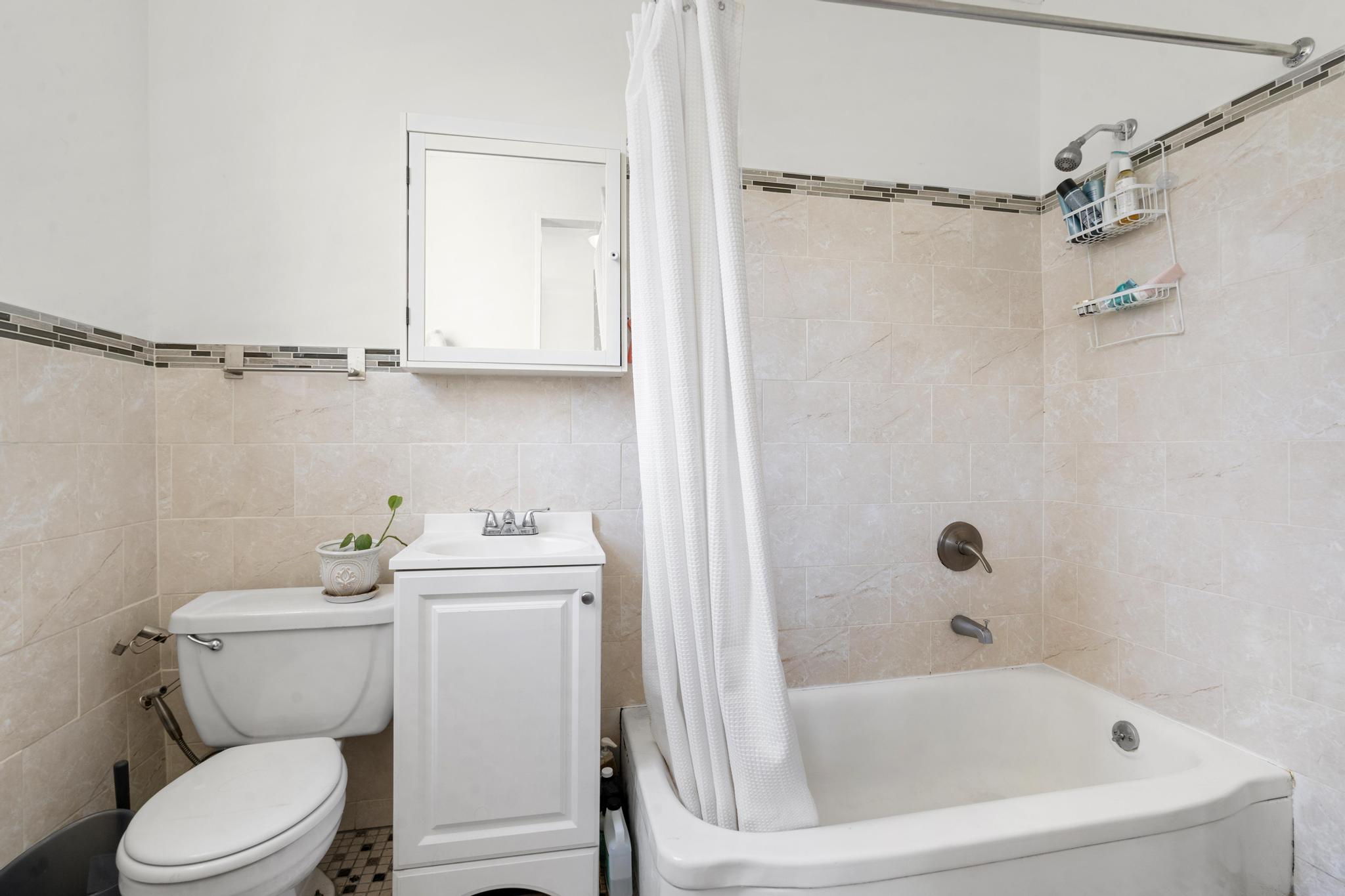 364 Clermont Avenue Brooklyn, NY 11238 - Photo 16 of 18 a white toilet sitting next to a bath tub