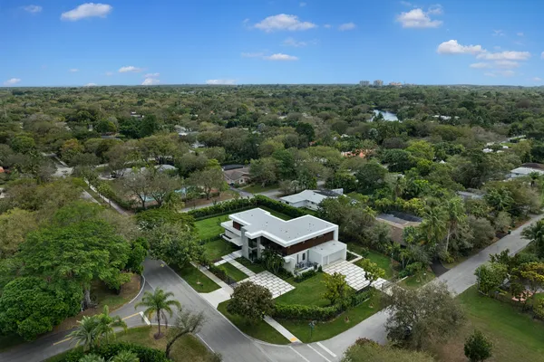 an aerial view of a house with a yard