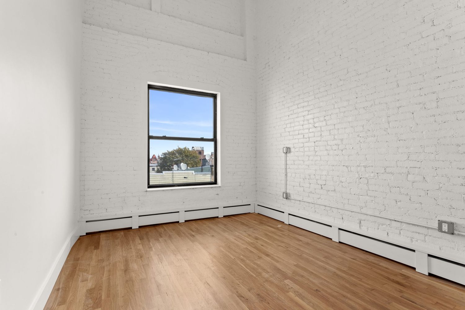 717 Manhattan Avenue, Unit 2A Brooklyn, NY 11222 - Photo 8 of 17 a view of a room with wooden floor and window