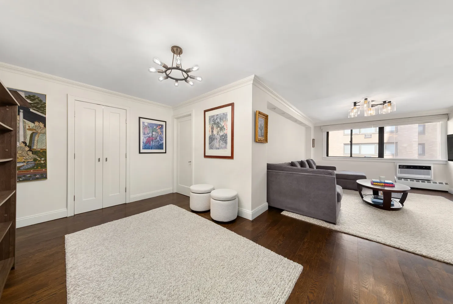 a living room with furniture and a chandelier