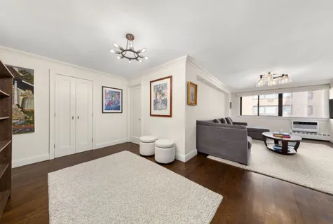 a living room with furniture and a chandelier