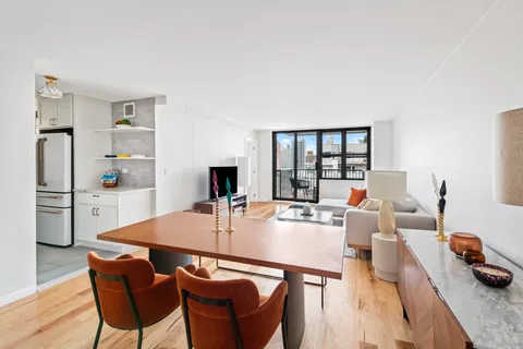 a living room with furniture a table and chairs