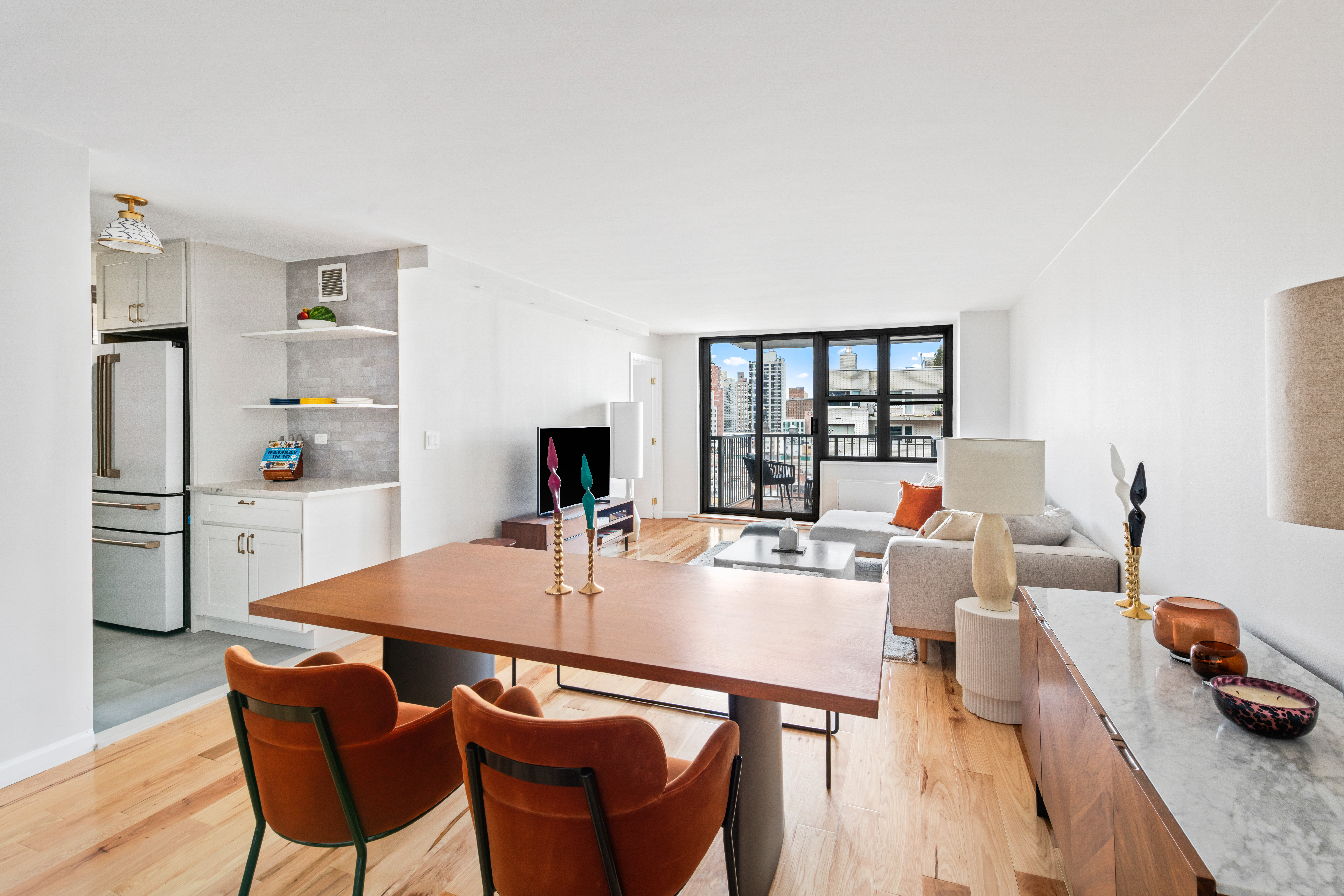 a living room with furniture a table and chairs