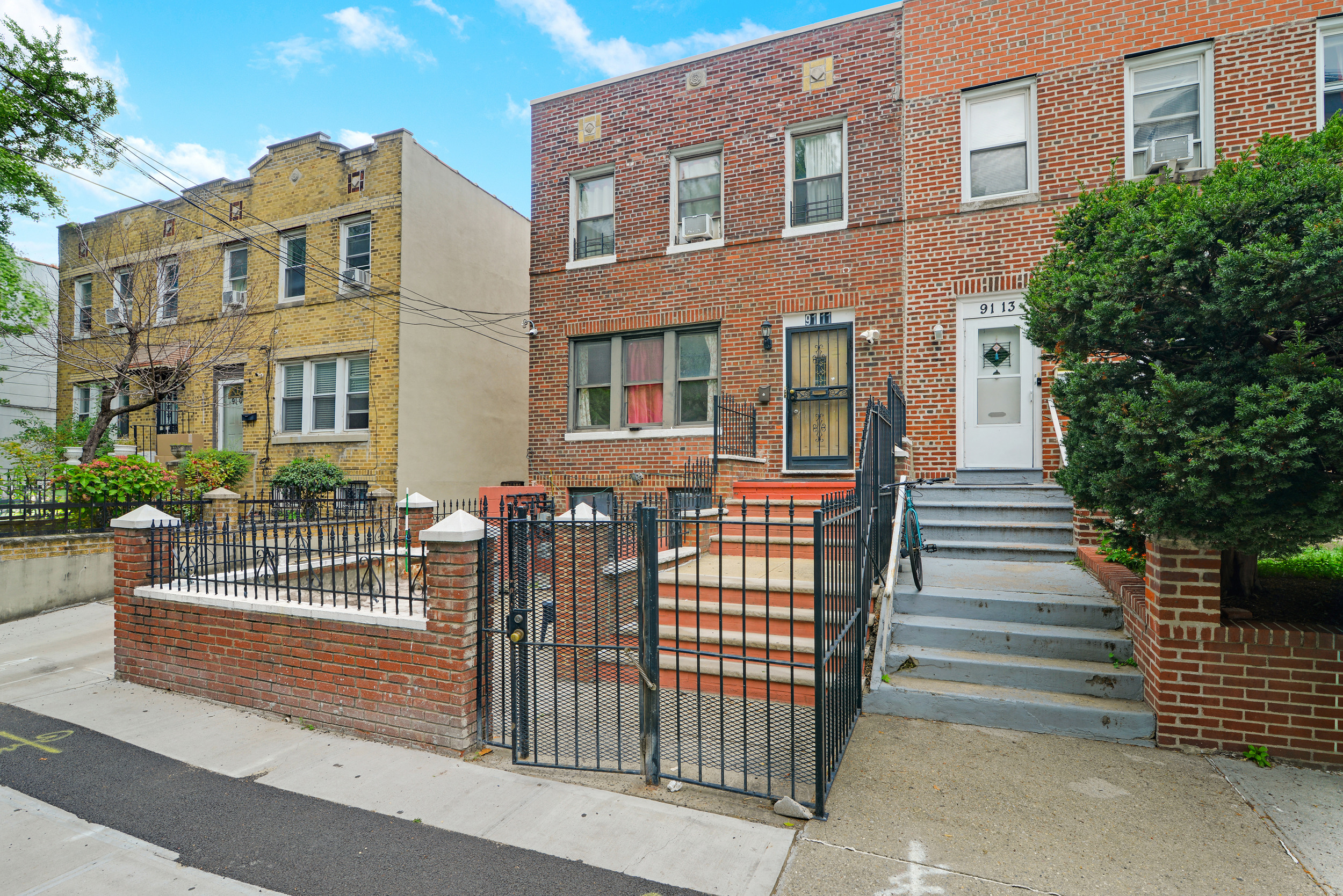 91-11 32nd Avenue, Unit 2 Queens, NY 11369 - Photo 8 of 9 a front view of a house with a garden