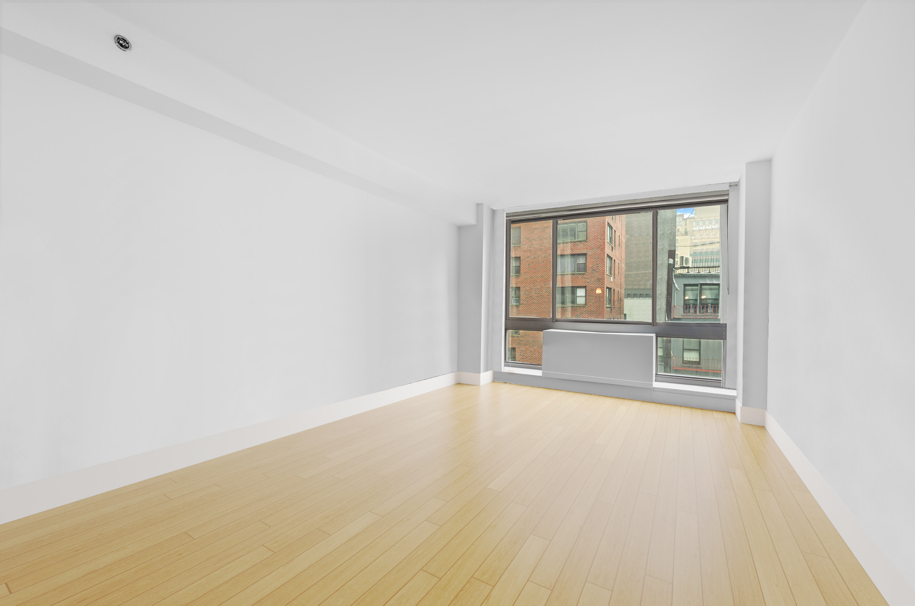 242 East 25th Street, Unit 5B Manhattan, NY 10010 - Photo 4 of 12 a view of an empty room with a window