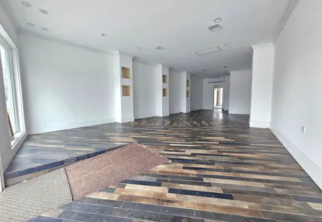 a view of a room with a sink and cabinets