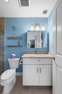 a bathroom with a sink toilet and mirror