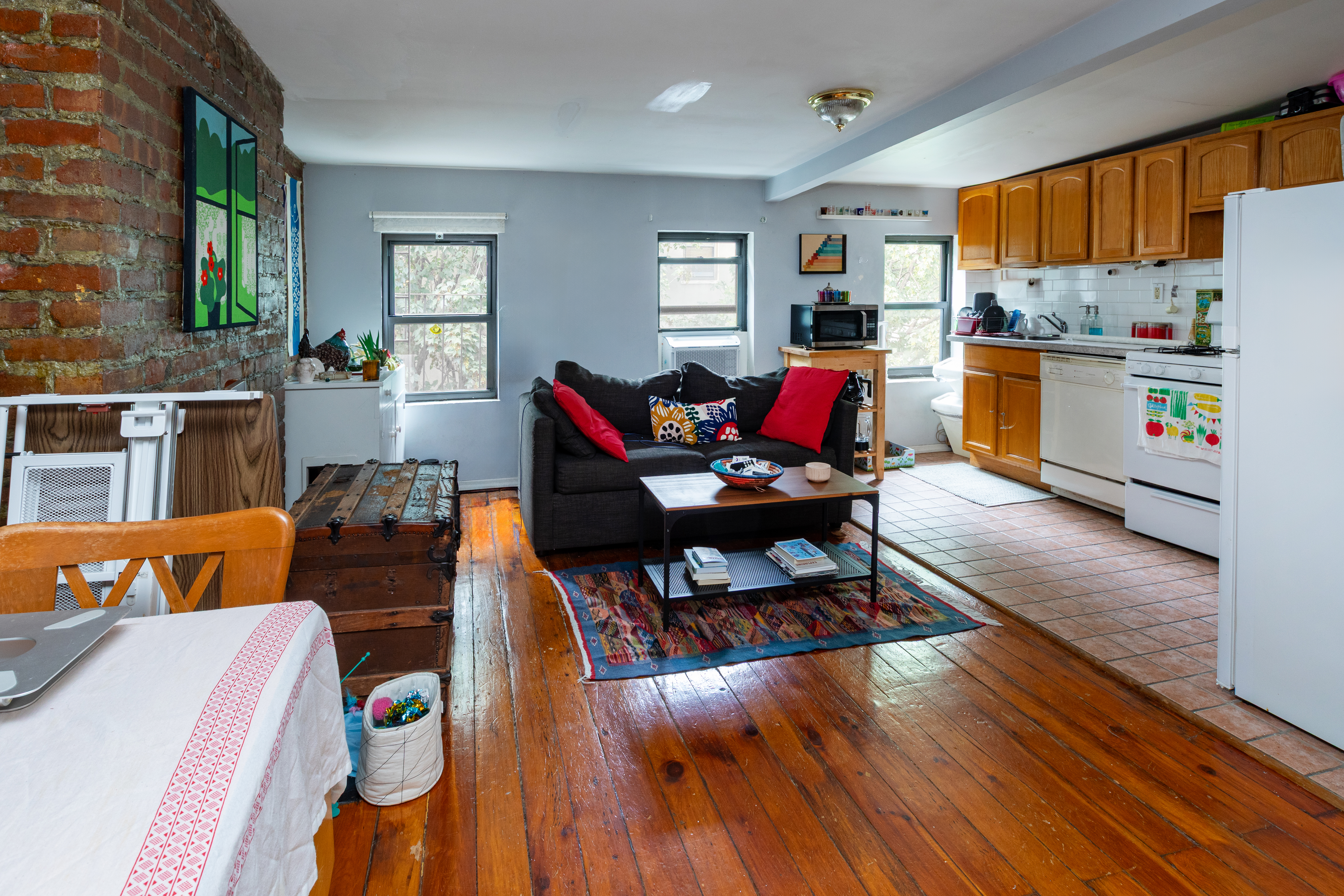 73 Monroe Street Brooklyn, NY 11216 - Photo 11 of 14 a living room with furniture and a wooden floor