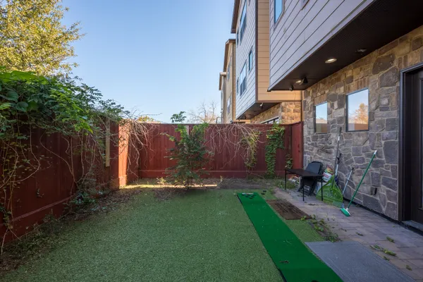 a backyard of a house with table and chairs