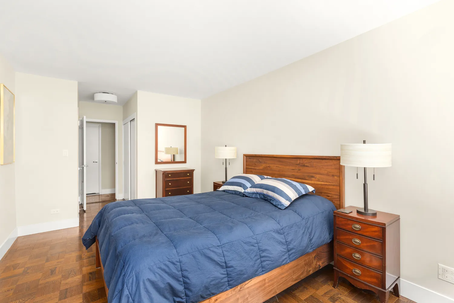 a bedroom with a bed and a lamp