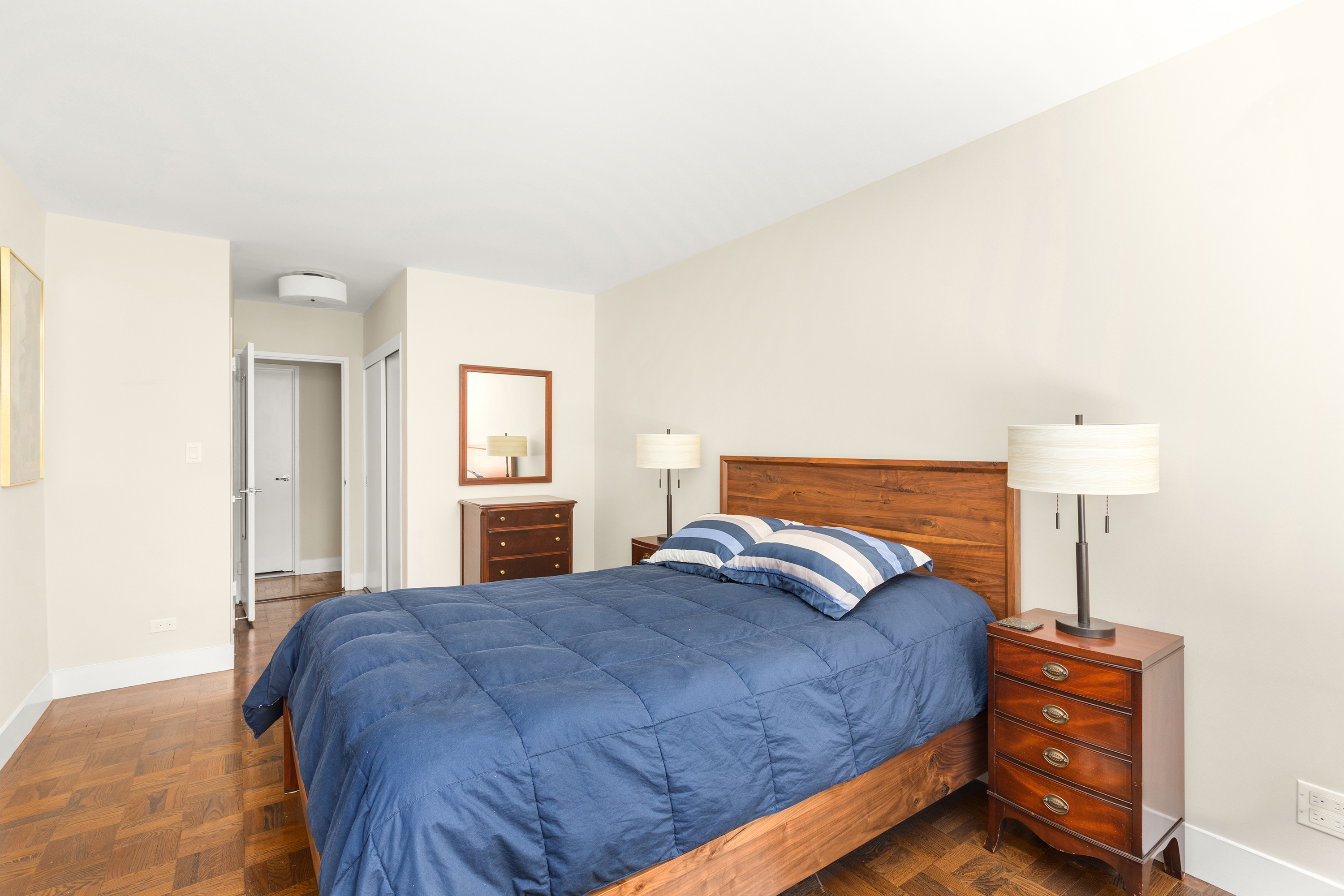 525 East 86th Street, Unit 2G Manhattan, NY 10028 - Photo 7 of 12 a bedroom with a bed and a lamp
