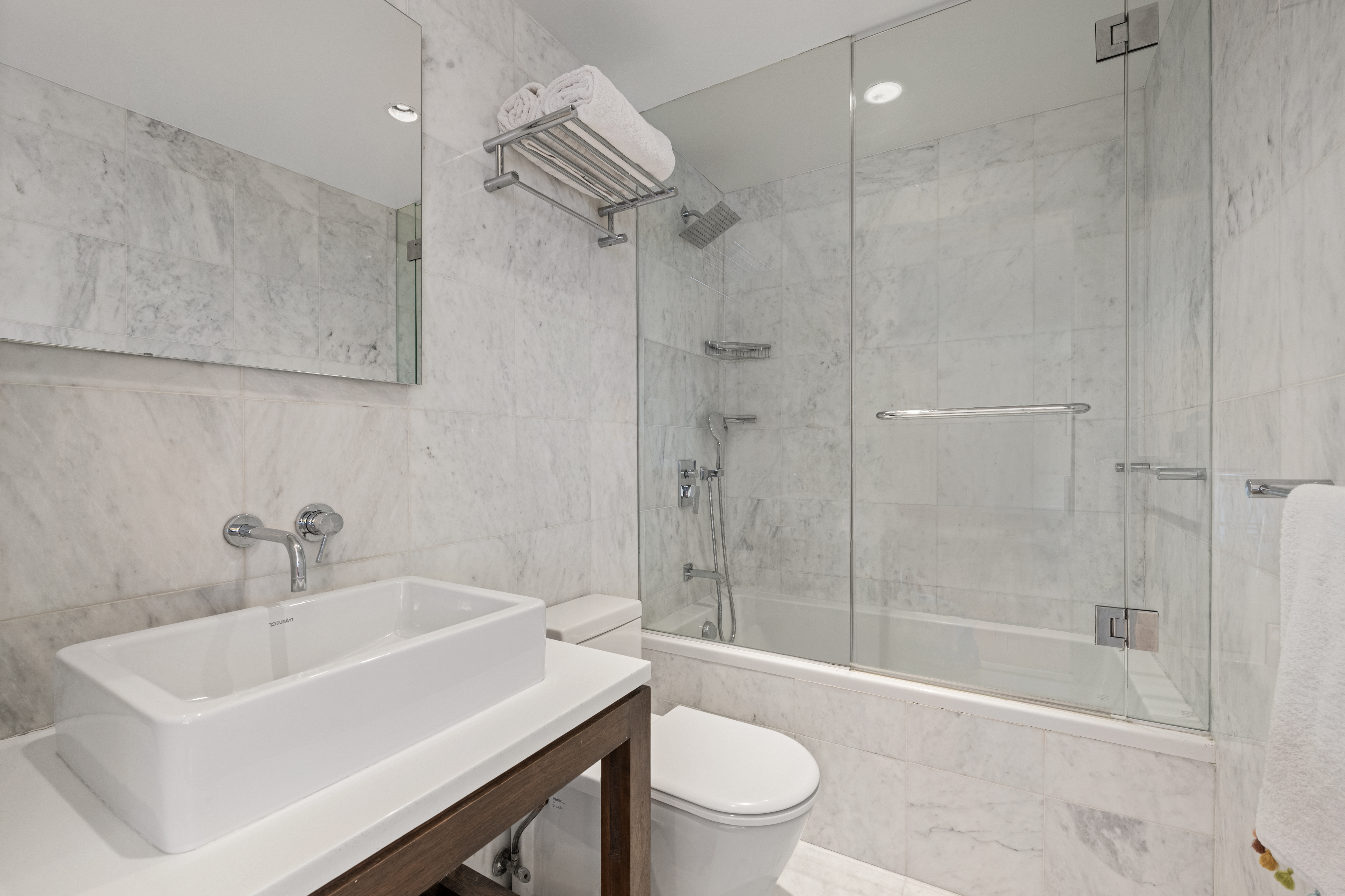 30 West 61st Street, Unit 9C Manhattan, NY 10023 - Photo 7 of 10 a bathroom with a sink toilet and shower