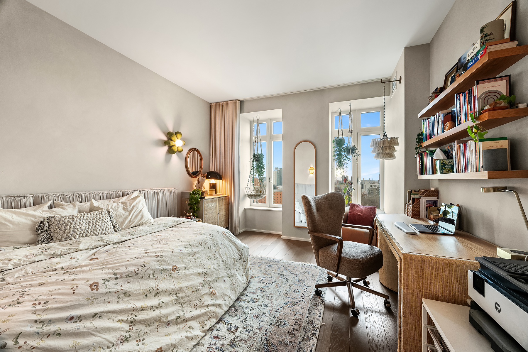 543 West 122nd Street, Unit 10E Manhattan, NY 10027 - Photo 8 of 12 a bedroom with a bed a book shelf and a workspace