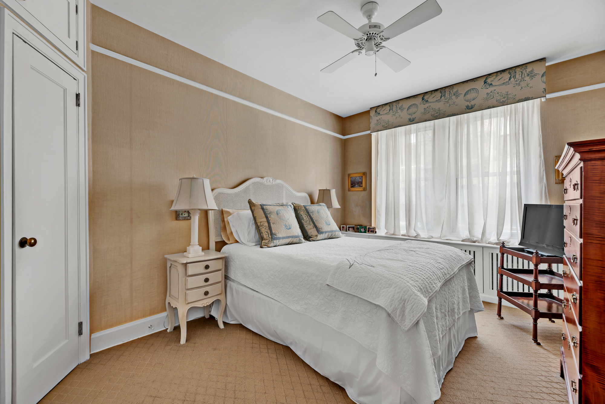 455 East 51st Street, Unit 6B Manhattan, NY 10022 - Photo 8 of 17 a bedroom with a bed and a chandelier