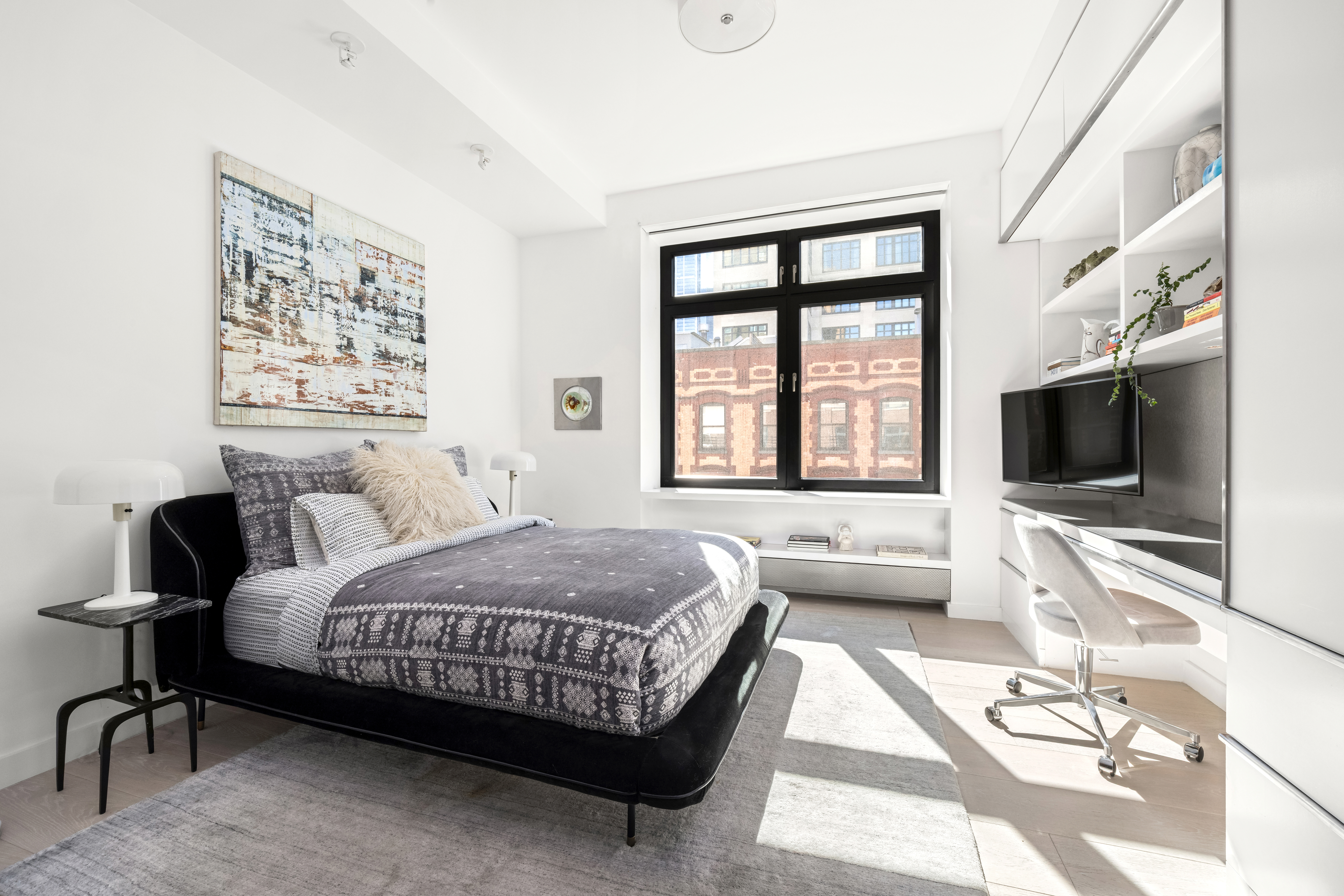 138 Reade Street, Unit 5 Manhattan, NY 10013 - Photo 16 of 23 a bedroom with a bed and a flat screen tv