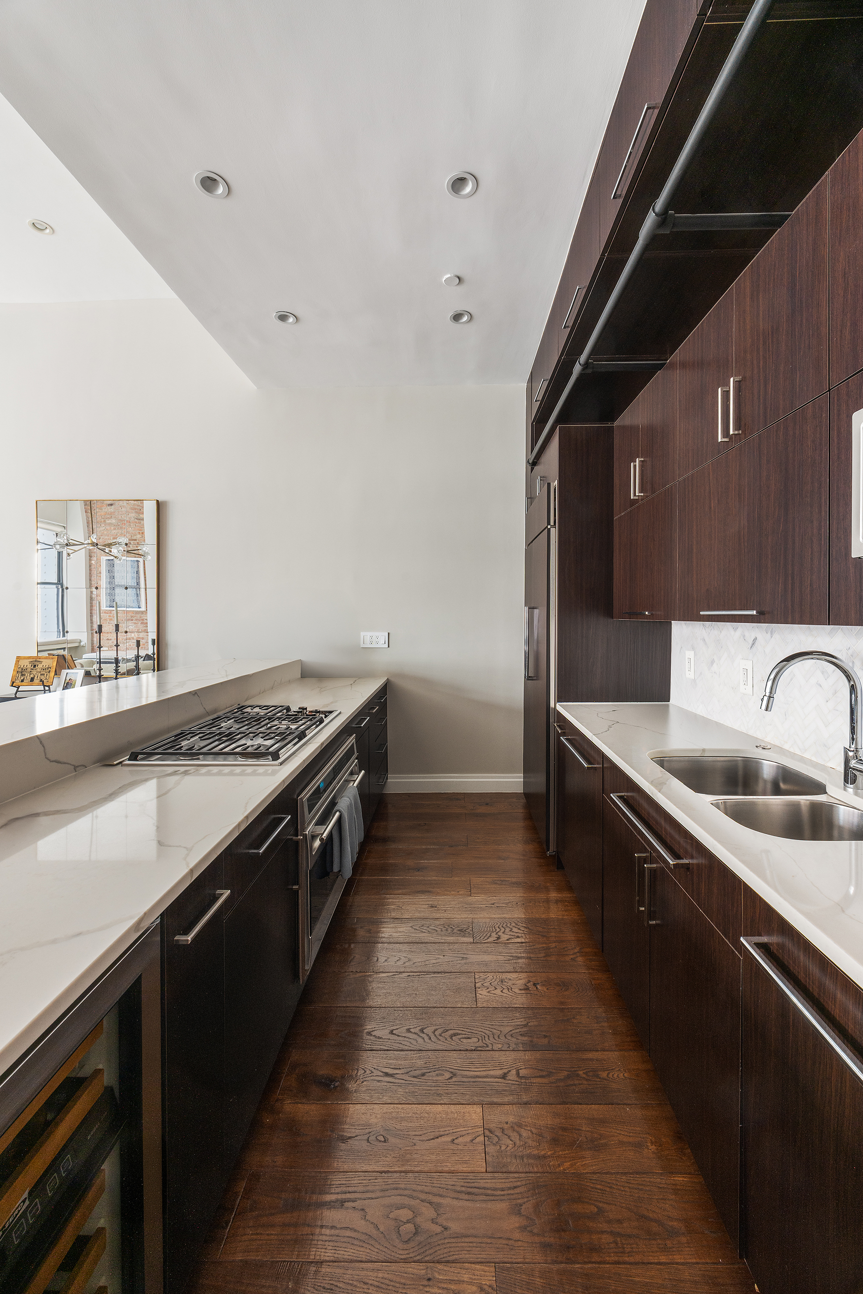 109 Greene Street, Unit 5A Manhattan, NY 10012 - Photo 10 of 18 a large kitchen with a stove and a sink