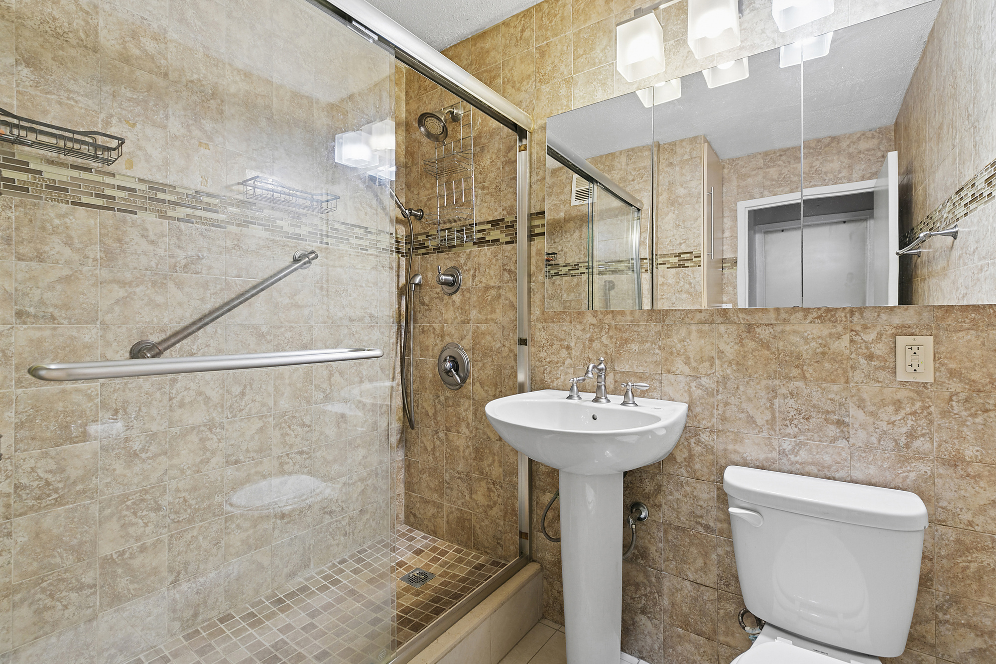 333 Pearl Street, Unit 6K Manhattan, NY 10038 - Photo 5 of 7 a bathroom with a sink a toilet and shower