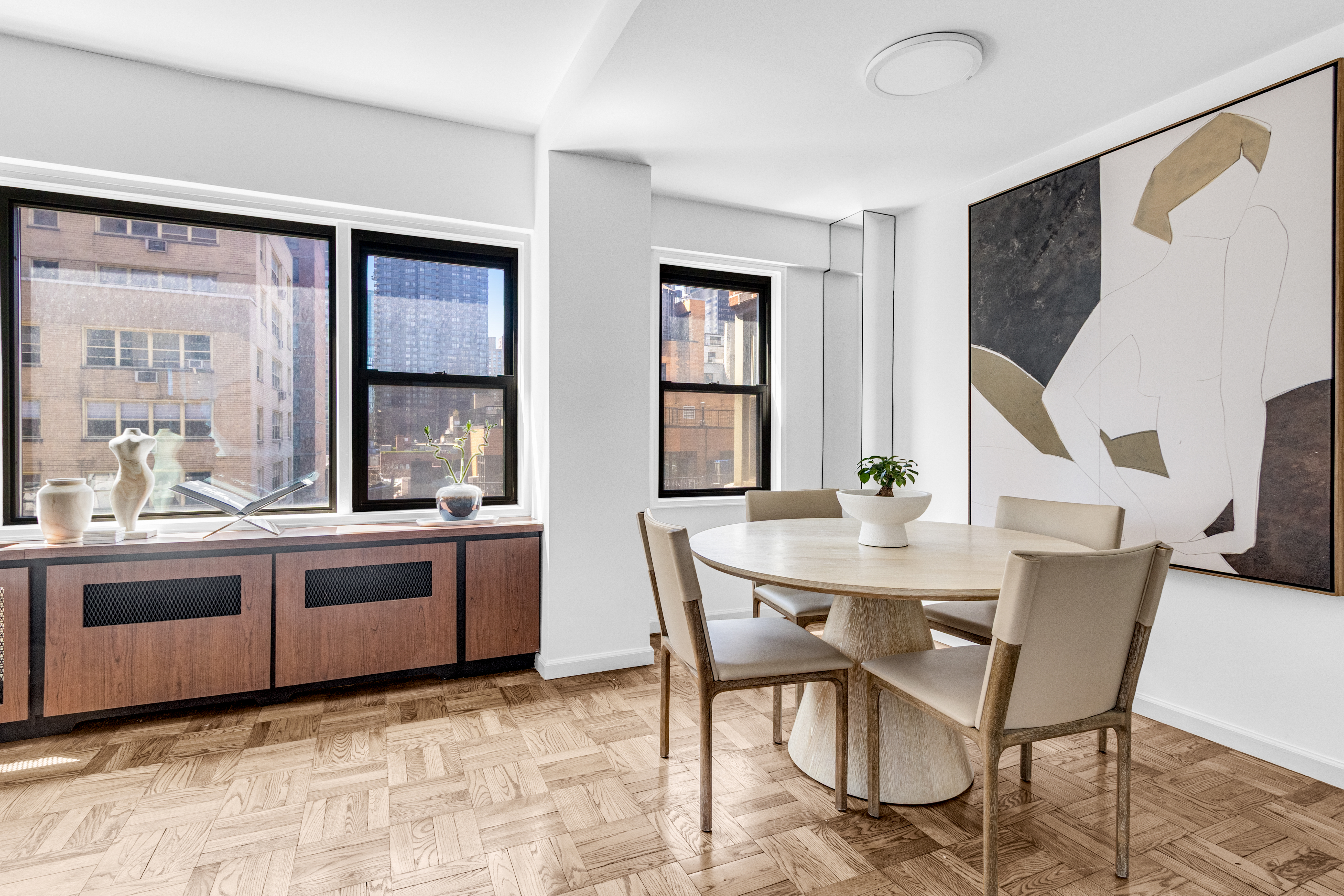 345 East 52nd Street, Unit 10CD Manhattan, NY 10022 - Photo 5 of 14 a view of a dining room with furniture and window