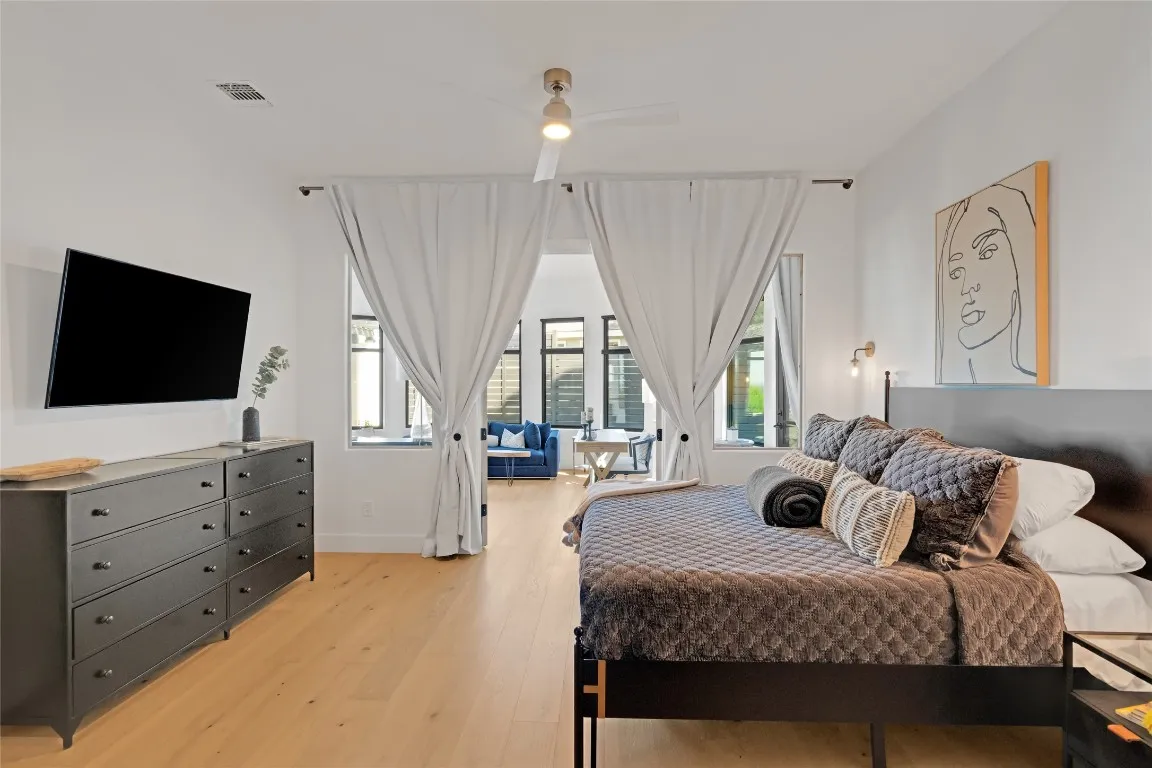 a living room with furniture large window and flat screen tv