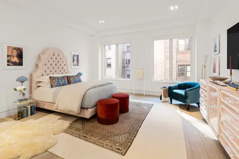 a spacious bedroom with a bed and glass windows