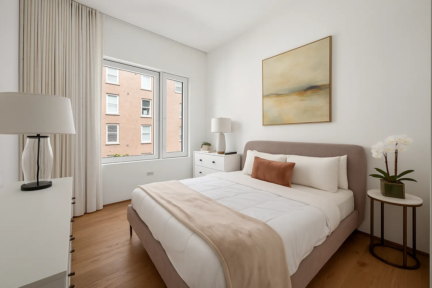 a bedroom with a bed and a painting on the wall