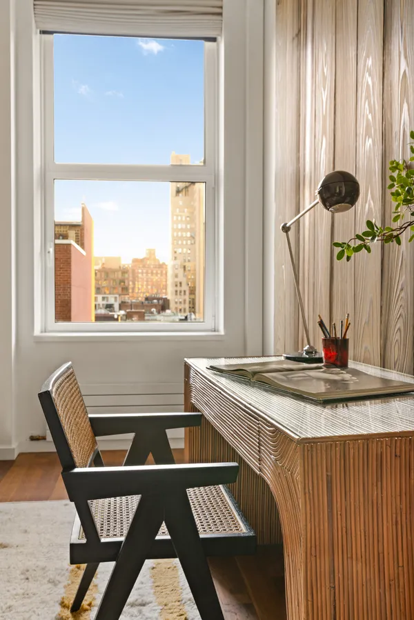 a room with table chairs and windows