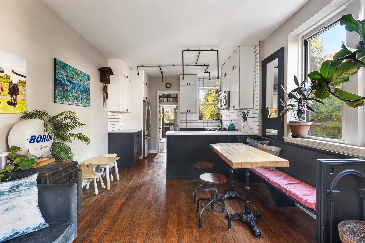 a dining room with furniture a window and wooden floor