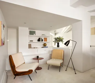 a living room with furniture and white walls