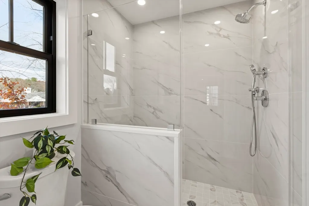 a bathroom with a bathtub and shower