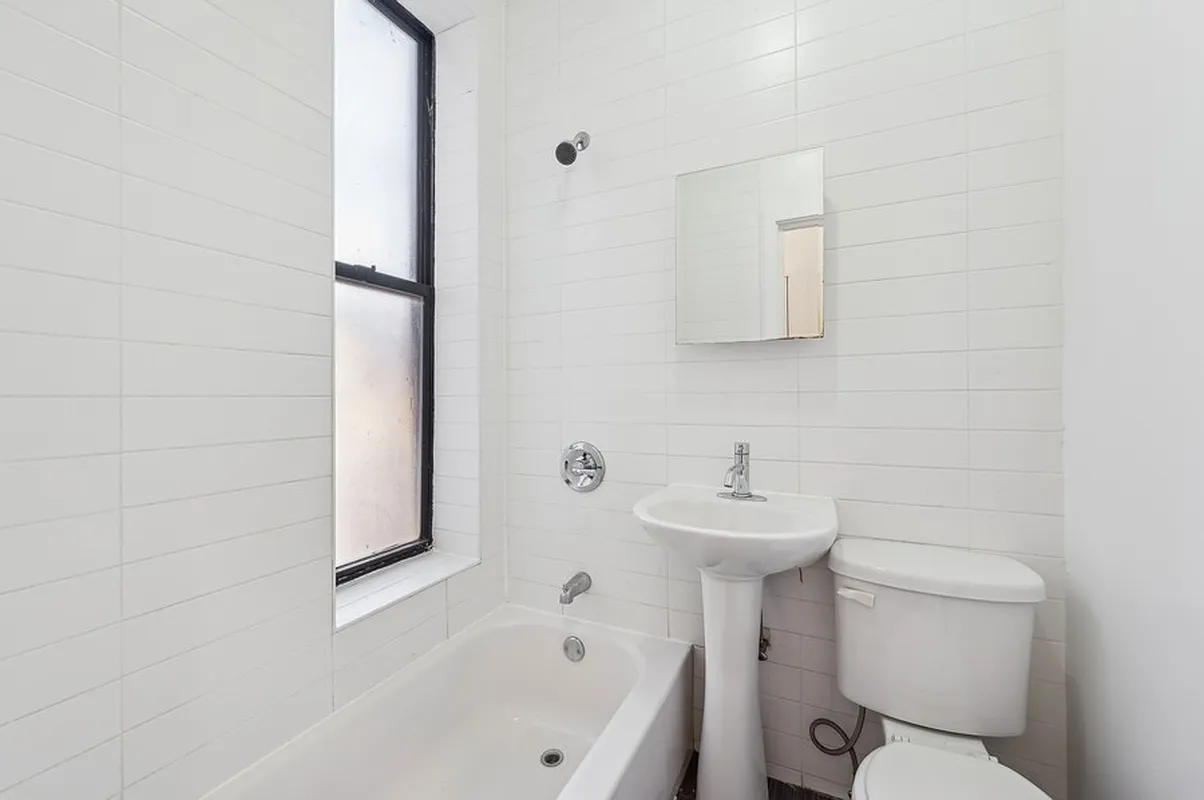 66 West 138th Street, Unit 1A Manhattan, NY 10037 - Photo 3 of 6 a bathroom with a sink a toilet and mirror