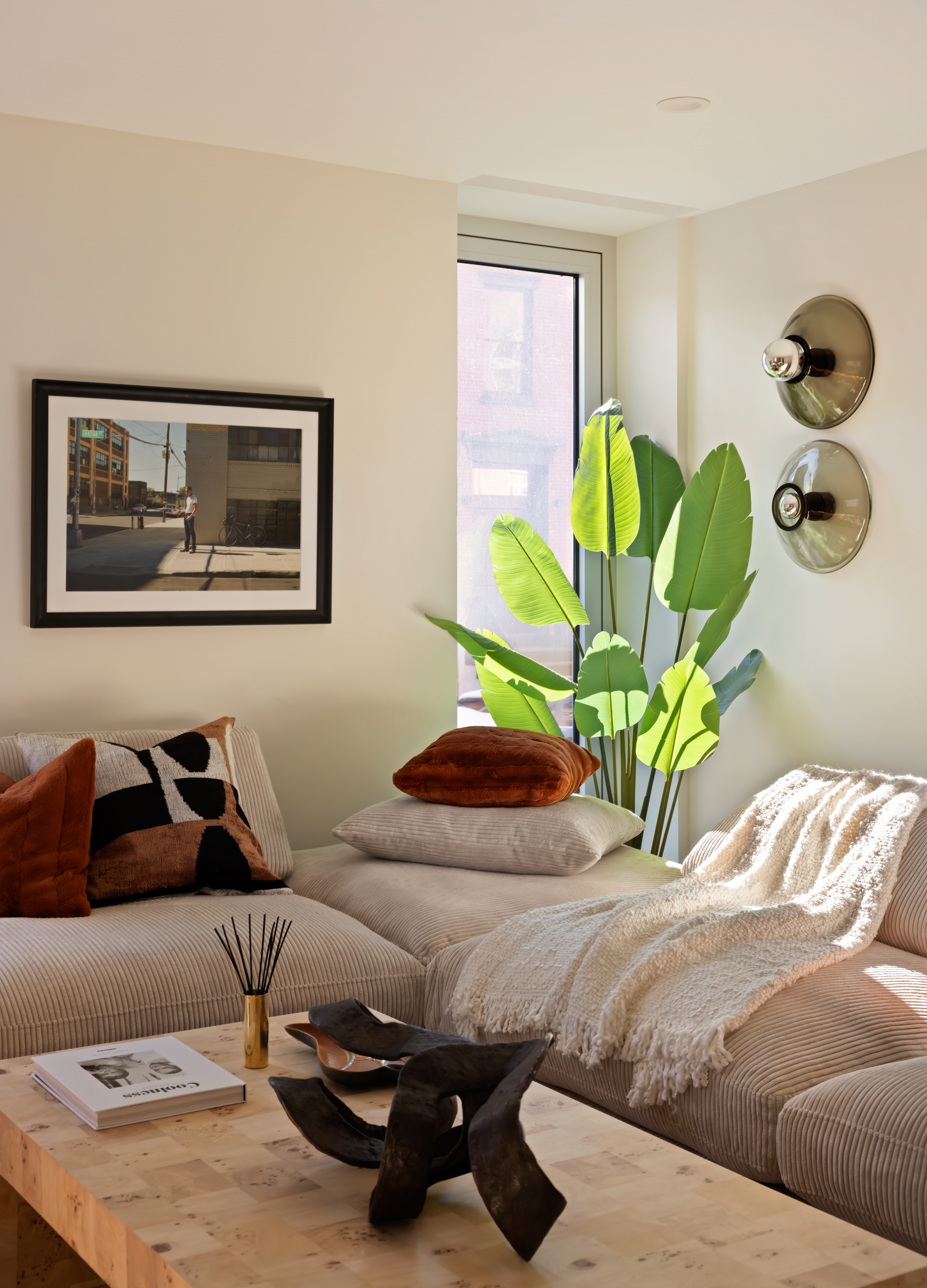 276 Berry Street Brooklyn, NY 11249 - Photo 15 of 36 a bedroom with a bed a couch and a potted plant