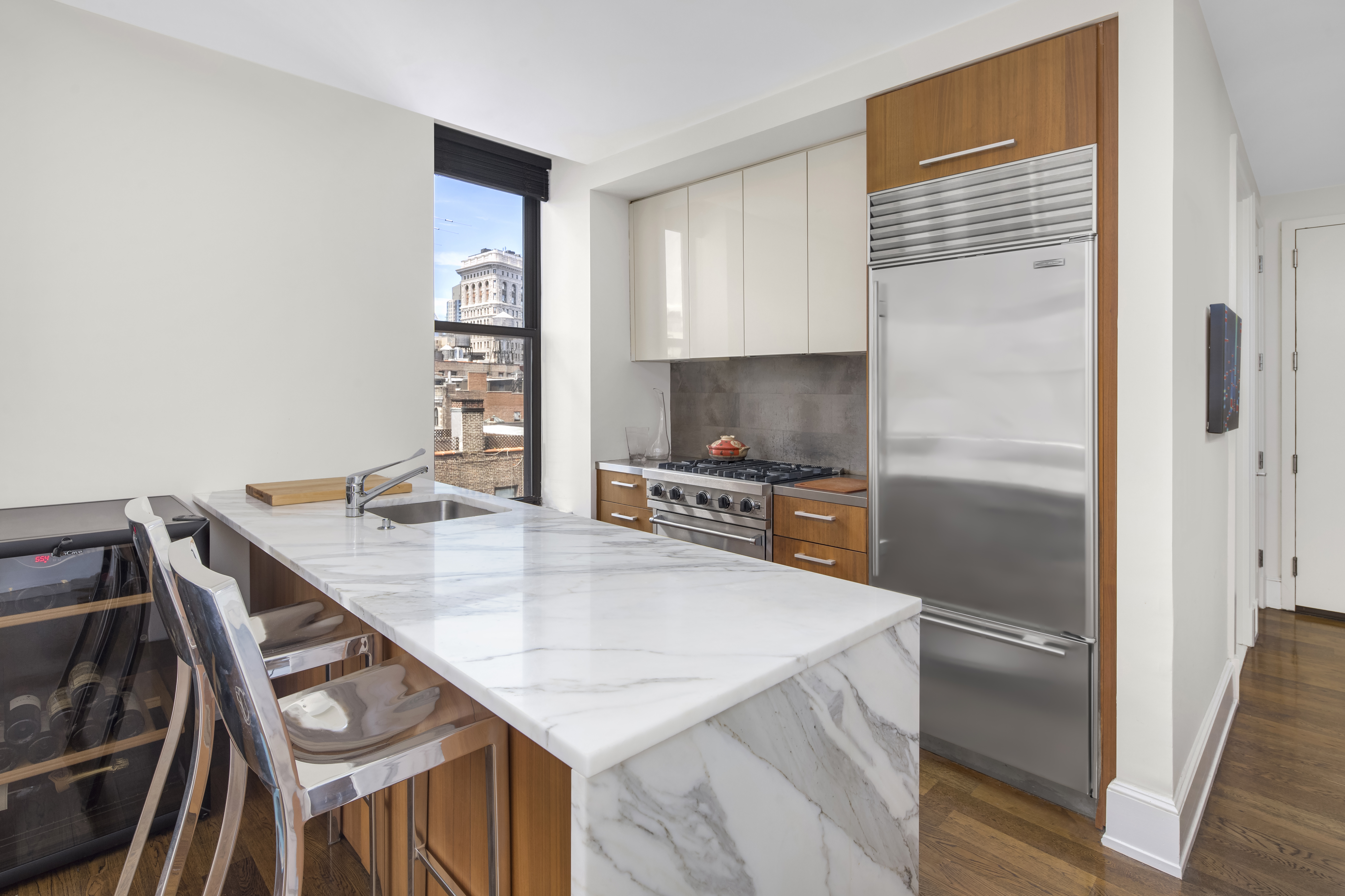 260 Park Avenue South, Unit 12F Manhattan, NY 10010 - Photo 3 of 9 a kitchen with kitchen island a counter top space appliances and cabinets