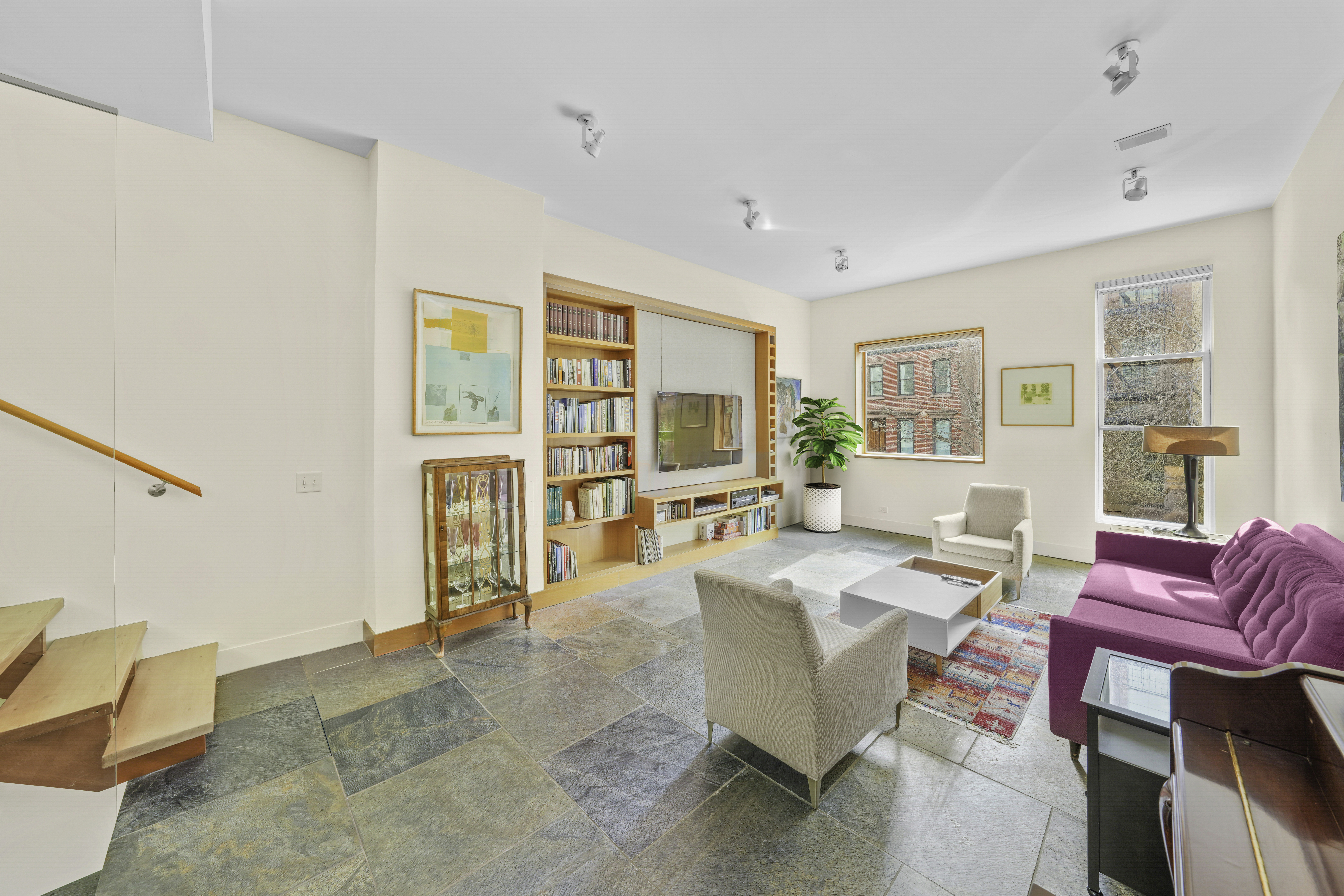 133 West 123rd Street Manhattan, NY 10027 - Photo 3 of 31 a living room with furniture a flat screen tv and a large window