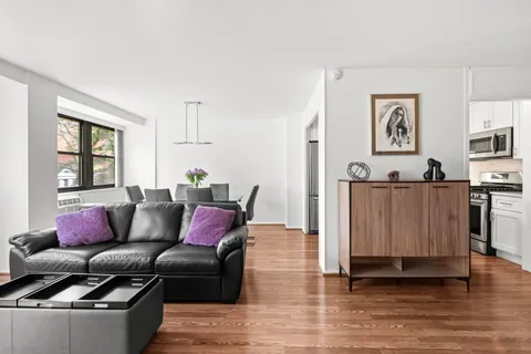 a living room with furniture and painting on the wall