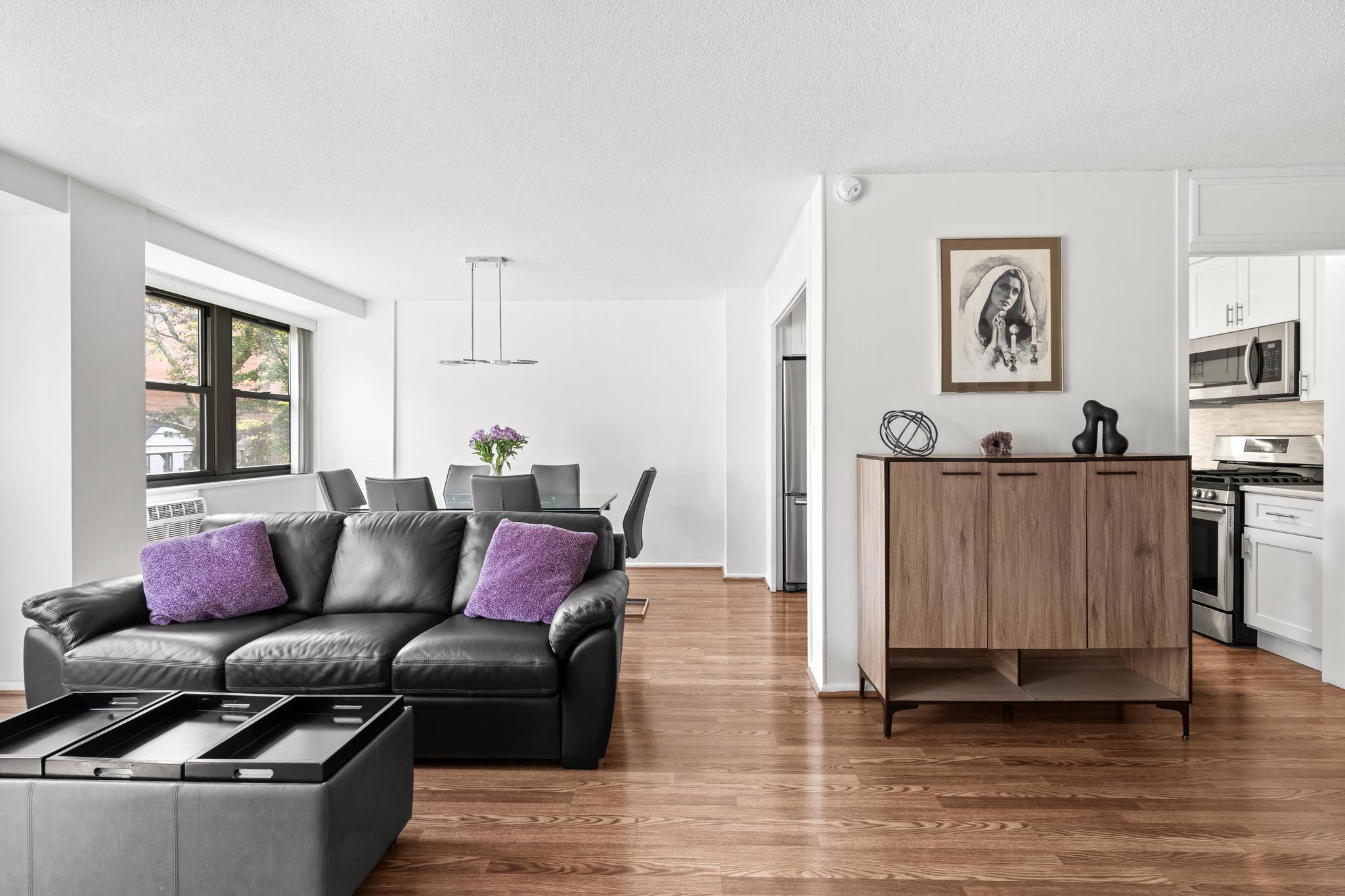 a living room with furniture and painting on the wall