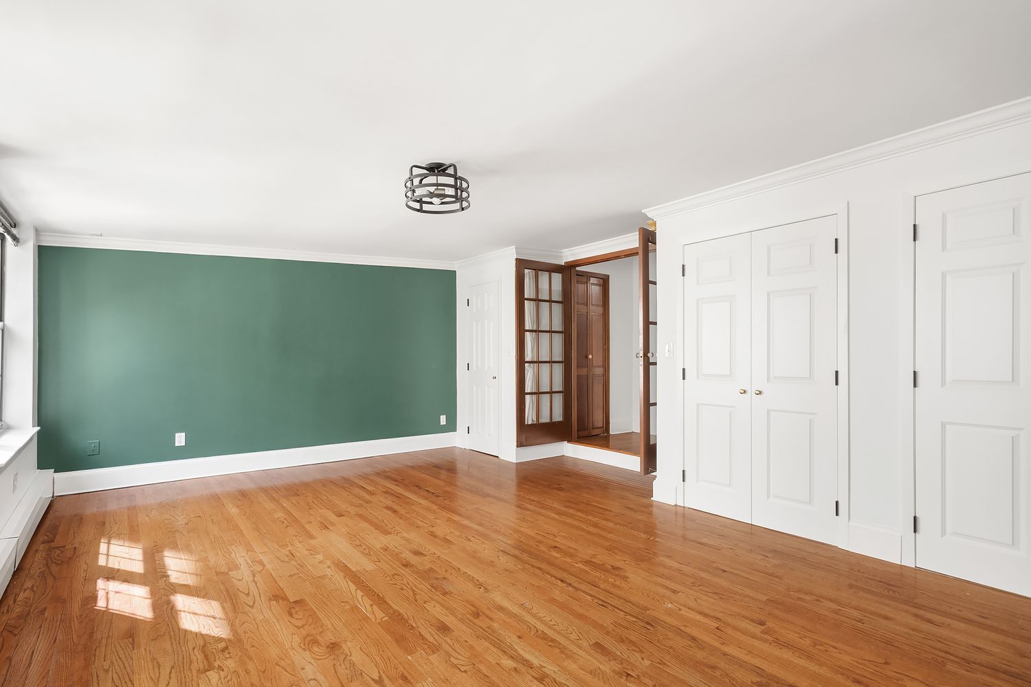 57 Sullivan Street, Unit 4 Manhattan, NY 10012 - Photo 7 of 11 a view of an empty room with wooden floor