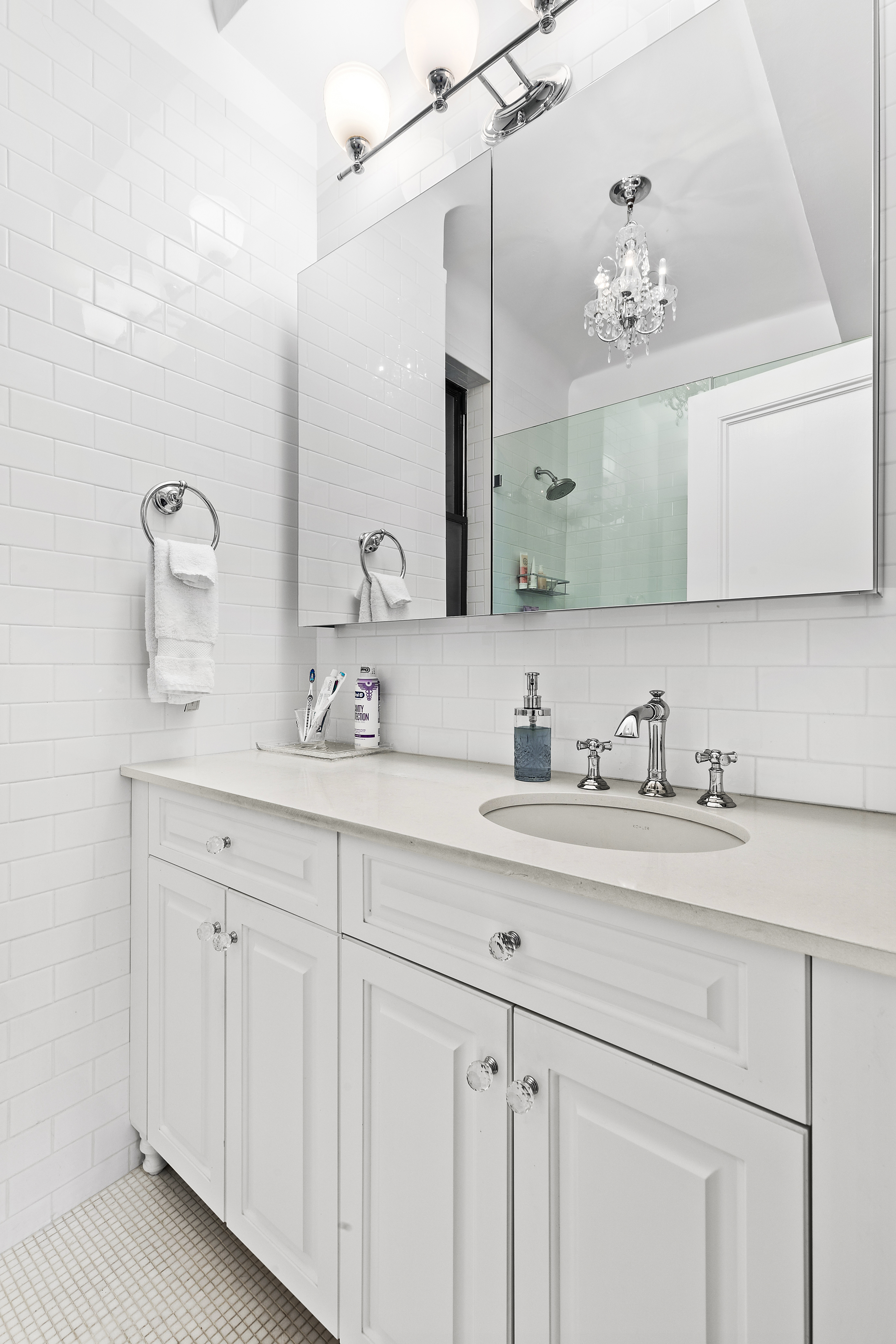 175 East 79th Street, Unit 3D Manhattan, NY 10075 - Photo 5 of 8 a bathroom with a sink double vanity and a mirror