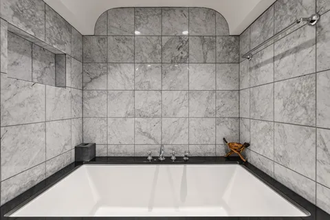 a bathroom with a bathtub and shower