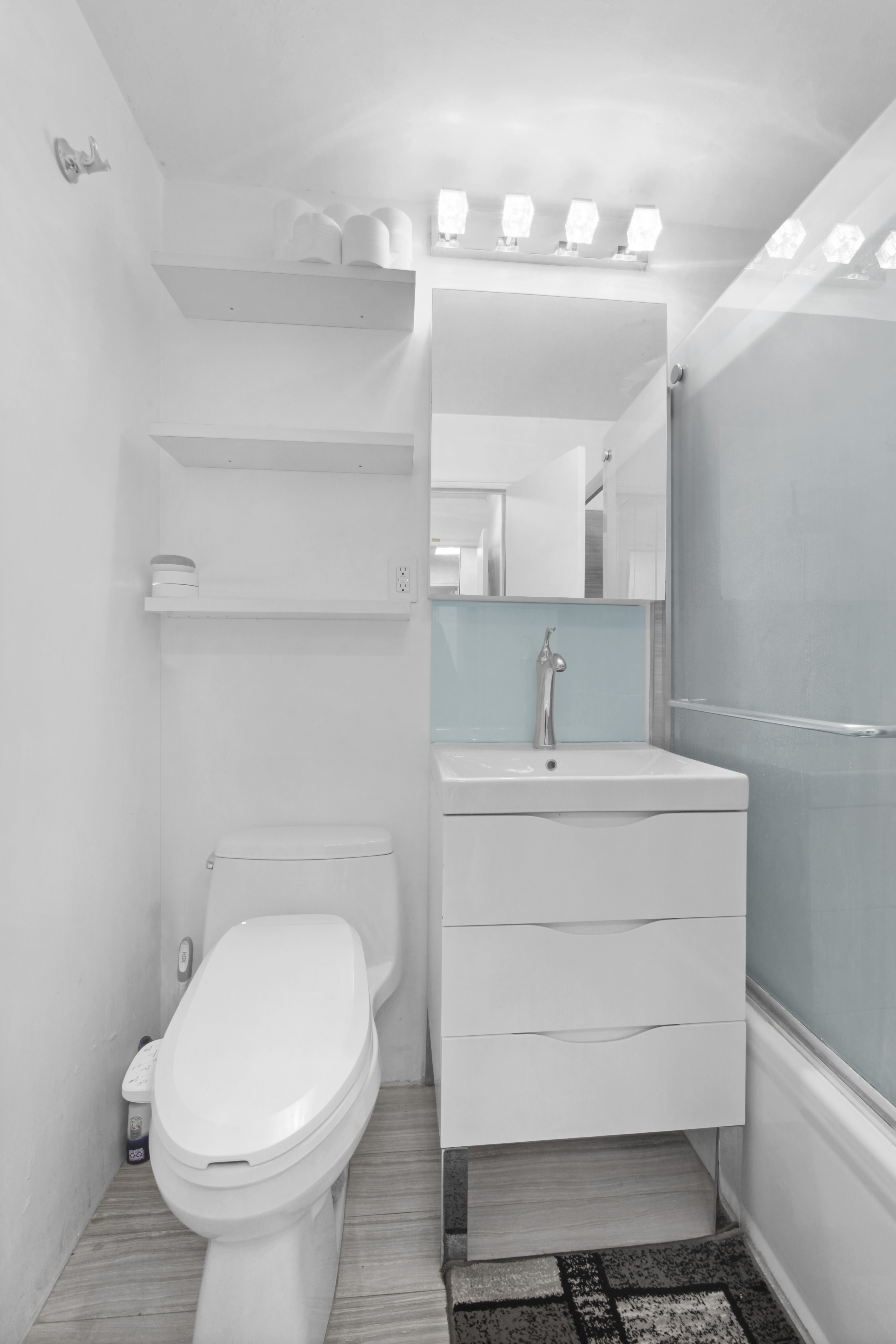 220 East 60th Street, Unit 5F Manhattan, NY 10022 - Photo 7 of 8 a bathroom with a sink and a mirror