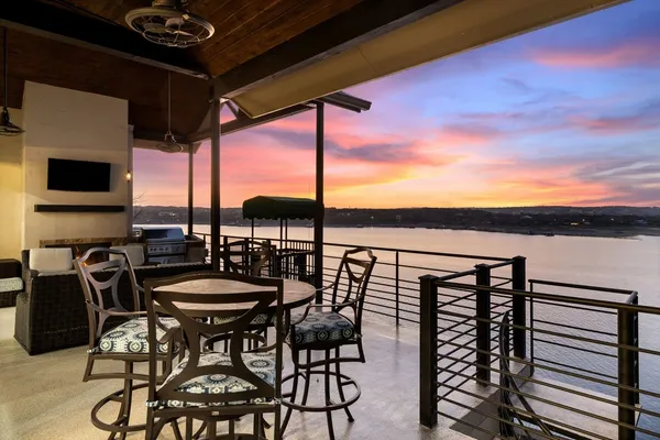 a view of a balcony dining space with furniture
